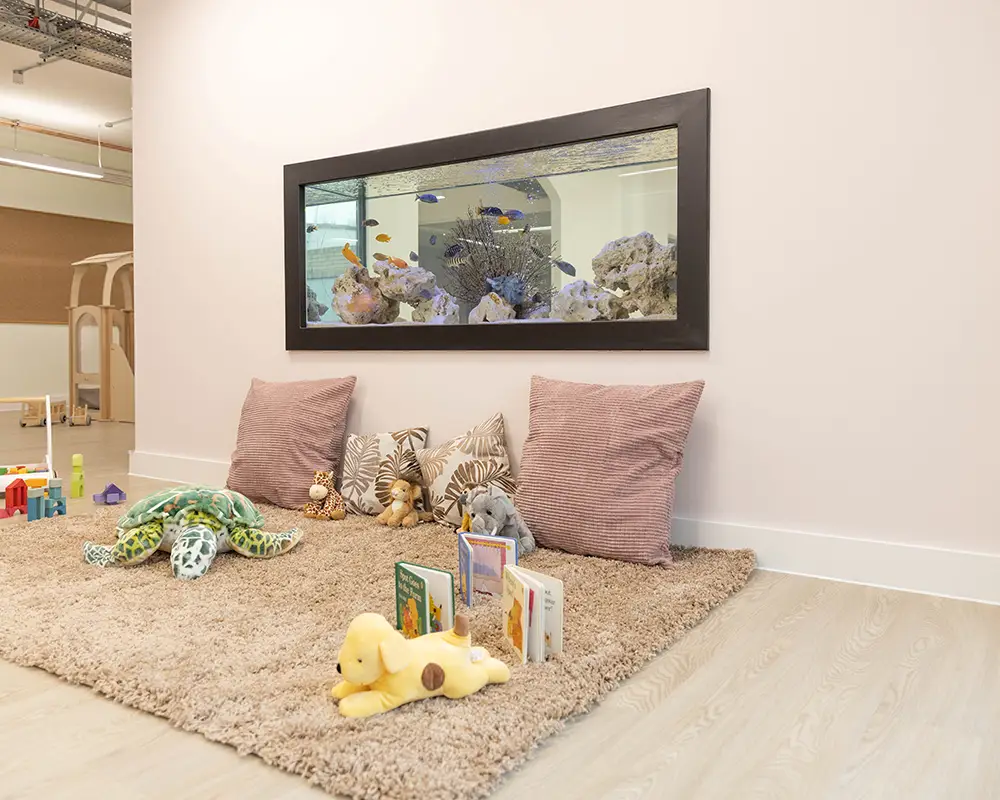 fish tank built in to nursery room for children to enjoy